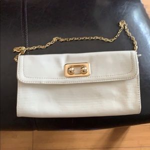 Cream clutch with gold tone chain shoulder strap